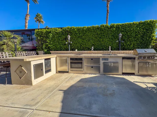 a view of a white house with a big yard