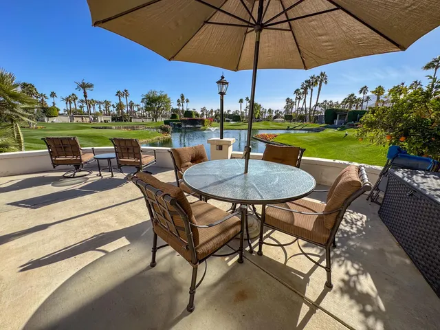a view of a table and chairs under an umbrella