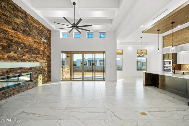 a kitchen with stainless steel appliances kitchen island granite countertop a refrigerator and a stove top oven