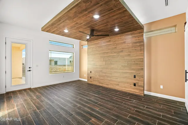 a view of a kitchen with a refrigerator and a stove top oven