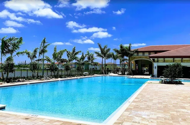 a view of swimming pool with outdoor seating and a yard