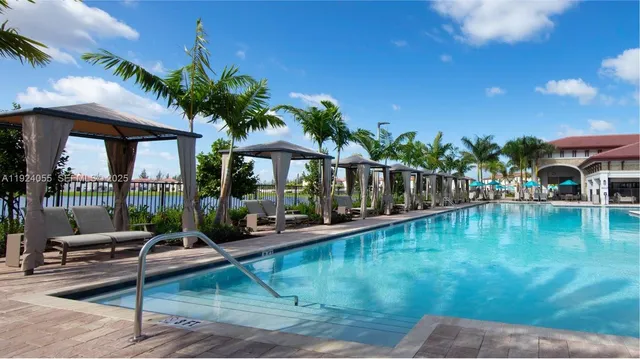 a view of a house with swimming pool and sitting area