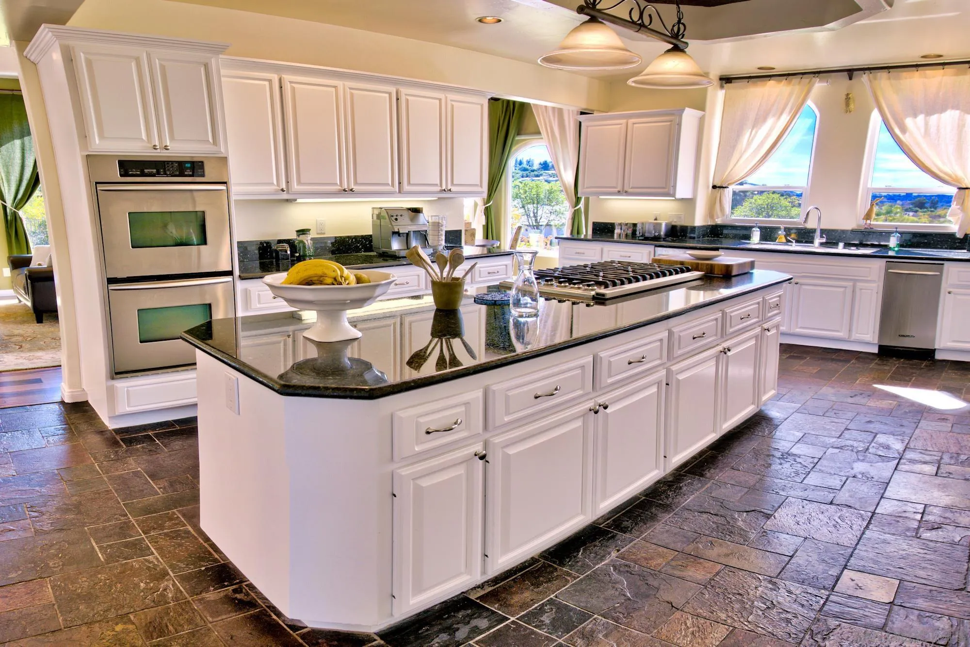 17843 Valle Verde Road Poway, CA 92064 - Photo 19 of 70 a kitchen with kitchen island granite countertop a sink a counter top space appliances and cabinets