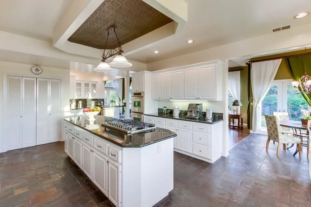 17843 Valle Verde Road Poway, CA 92064 - Photo 22 of 70 a kitchen with stainless steel appliances granite countertop a lot of counter space and wooden floors
