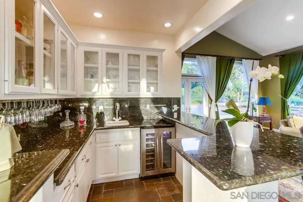 17843 Valle Verde Road Poway, CA 92064 - Photo 29 of 70 a kitchen with stainless steel appliances granite countertop a sink and cabinets