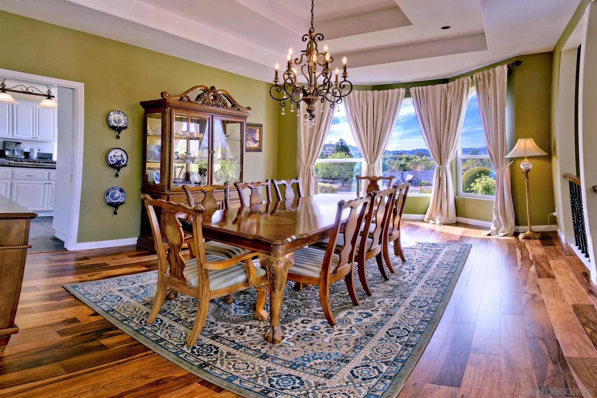 17843 Valle Verde Road Poway, CA 92064 - Photo 30 of 70 a view of a dining room with furniture a chandelier and wooden floor