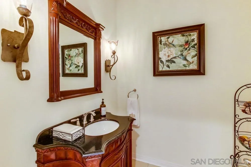 17843 Valle Verde Road Poway, CA 92064 - Photo 34 of 70 a bathroom with a sink and a mirror