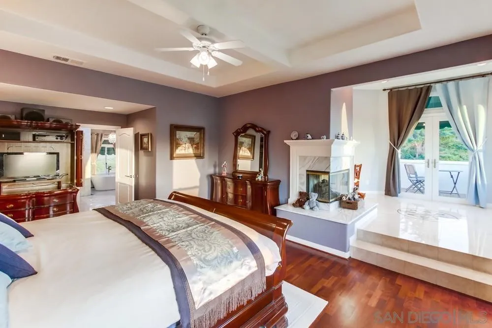 17843 Valle Verde Road Poway, CA 92064 - Photo 37 of 70 a bedroom with a bed a large window and flat screen tv