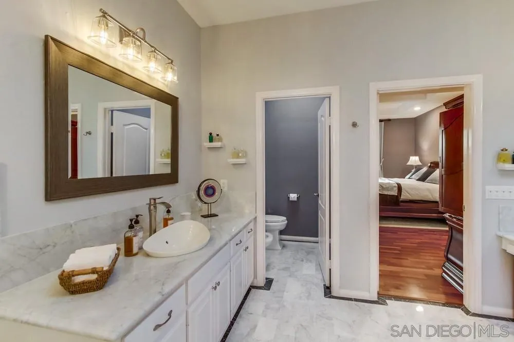 17843 Valle Verde Road Poway, CA 92064 - Photo 46 of 70 a en suite bathroom with a double vanity sink and a mirror