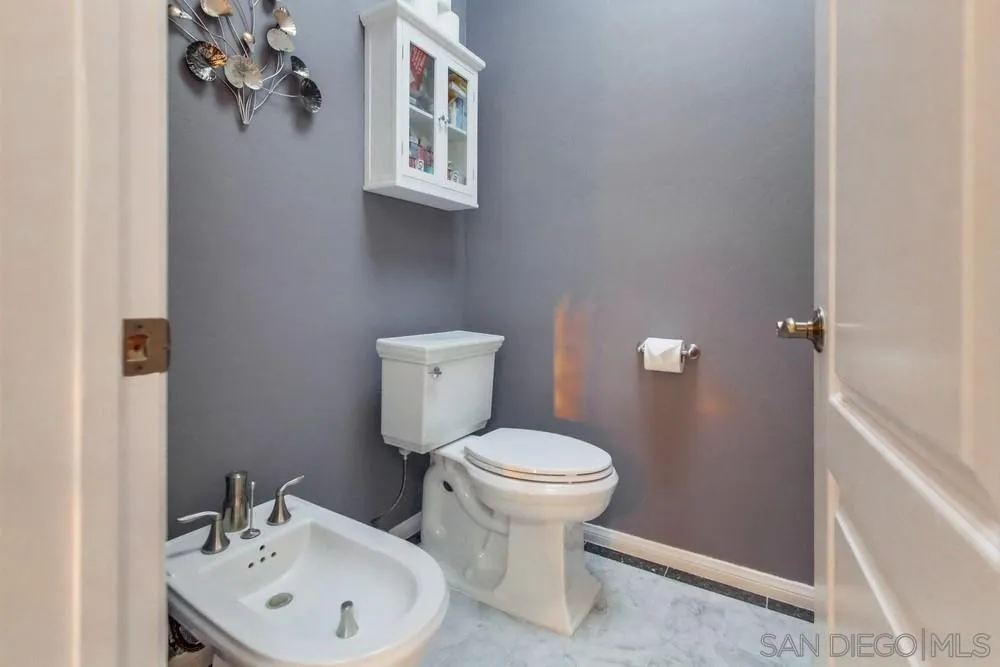 17843 Valle Verde Road Poway, CA 92064 - Photo 47 of 70 a bathroom with a toilet sink and mirror