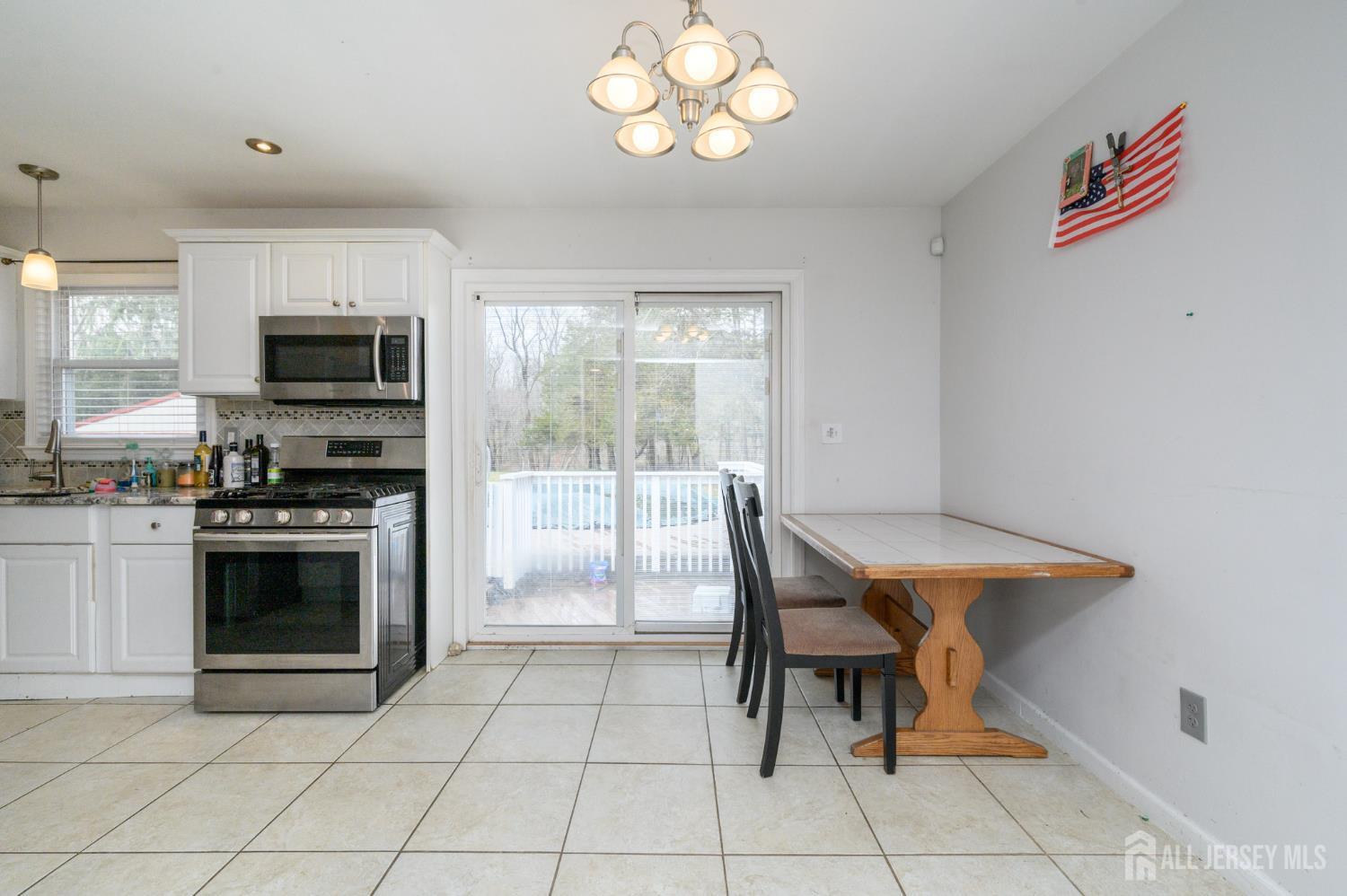 384 Cook Road Jackson, NJ 08527 - Photo 7 of 31 a kitchen with stainless steel appliances a stove a sink and a refrigerator
