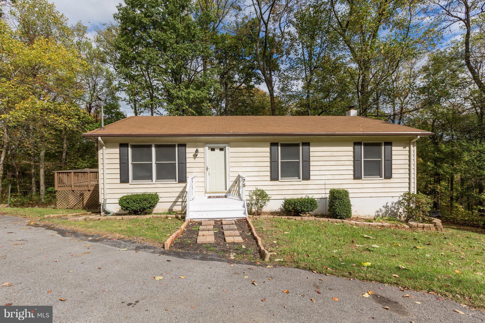 75 Locust Tree Lane Front Royal, VA 22630 - Photo 1 of 27 a front view of a house with garden