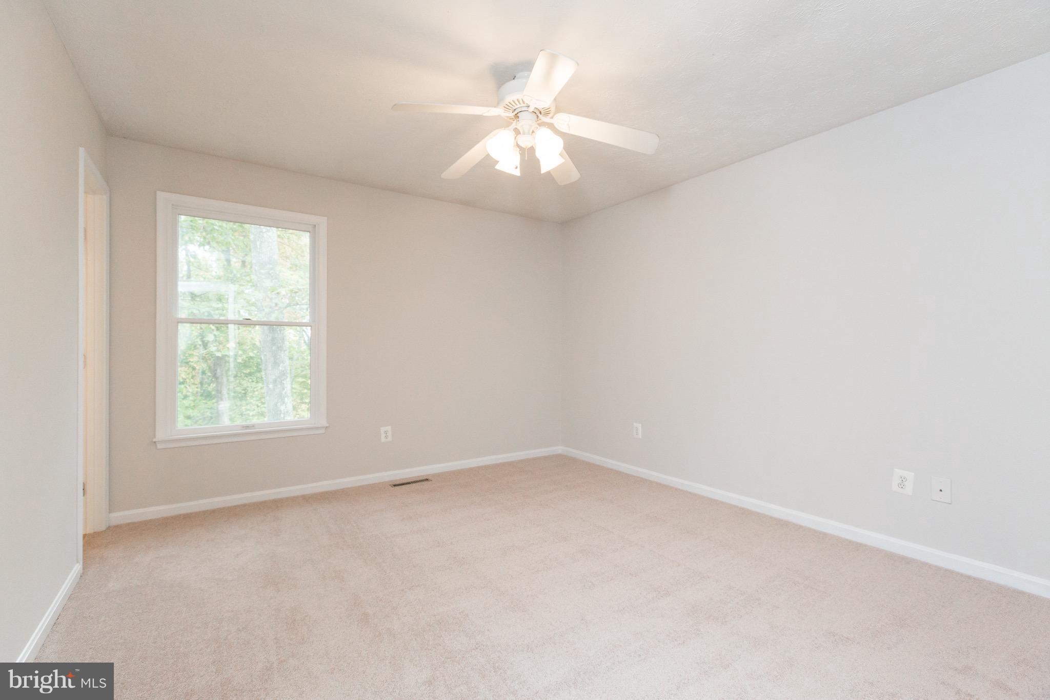 75 Locust Tree Lane Front Royal, VA 22630 - Photo 11 of 27 an empty room with a window and a fan