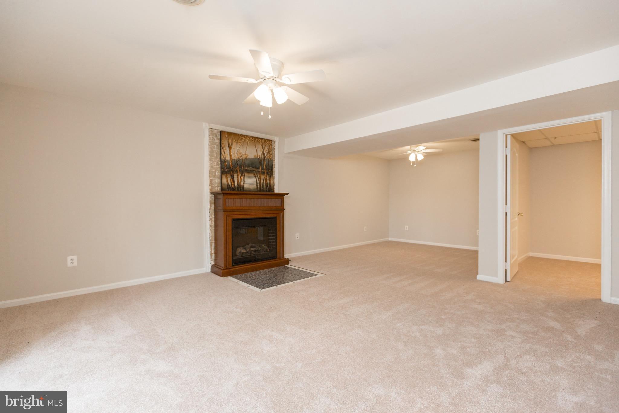 75 Locust Tree Lane Front Royal, VA 22630 - Photo 17 of 27 a view of an empty room with chandelier fan and fire place