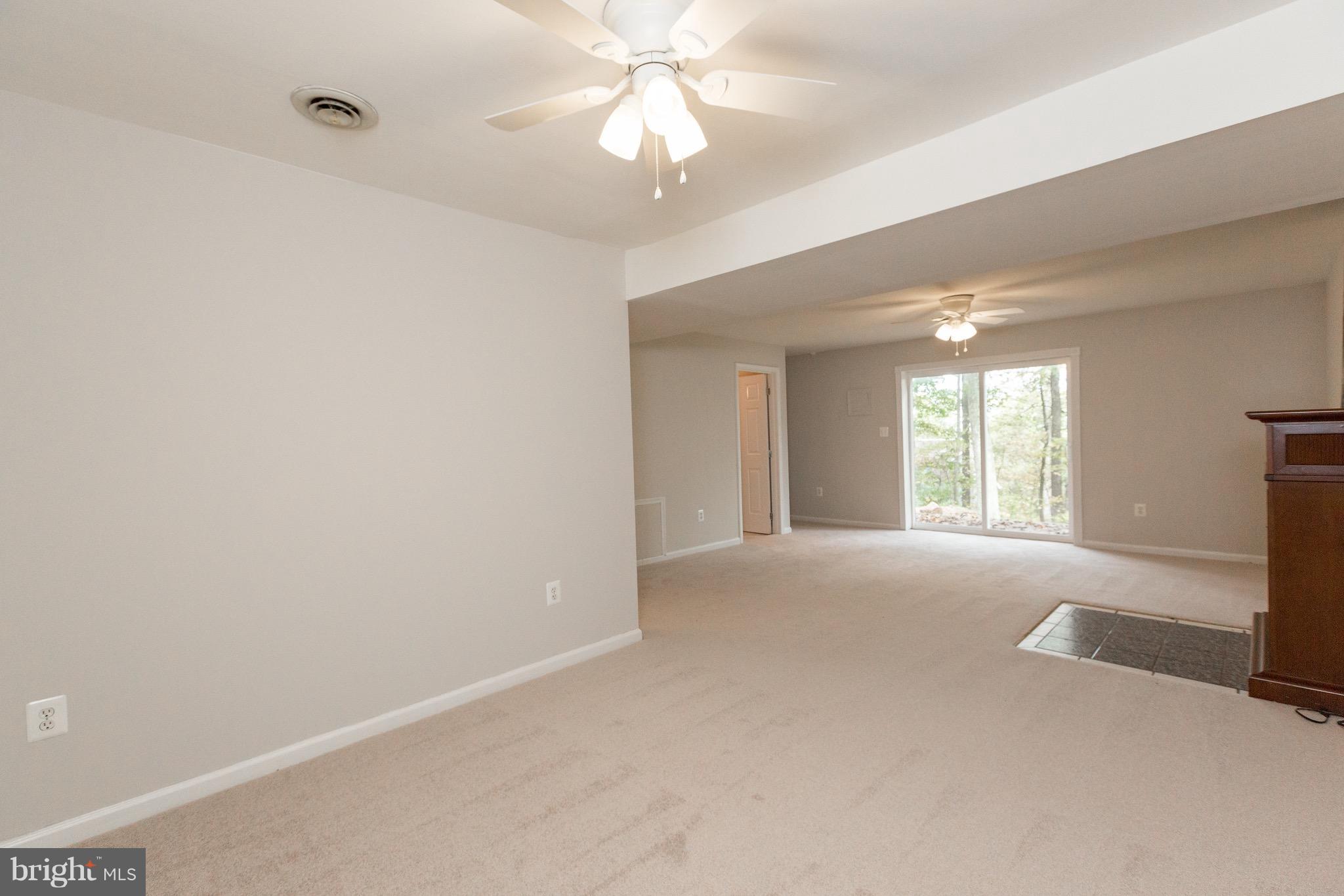 75 Locust Tree Lane Front Royal, VA 22630 - Photo 18 of 27 a view of an empty room with window and chandelier fan