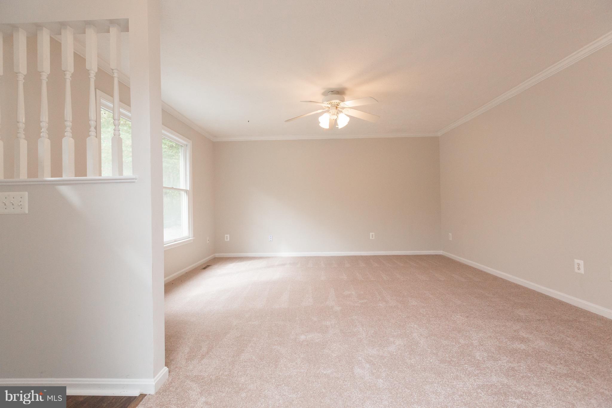 75 Locust Tree Lane Front Royal, VA 22630 - Photo 4 of 27 an empty room with a window and a ceiling fan