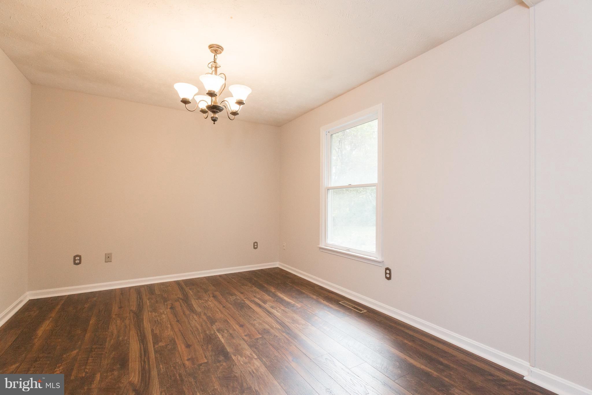 75 Locust Tree Lane Front Royal, VA 22630 - Photo 5 of 27 wooden floor in an empty room with a window