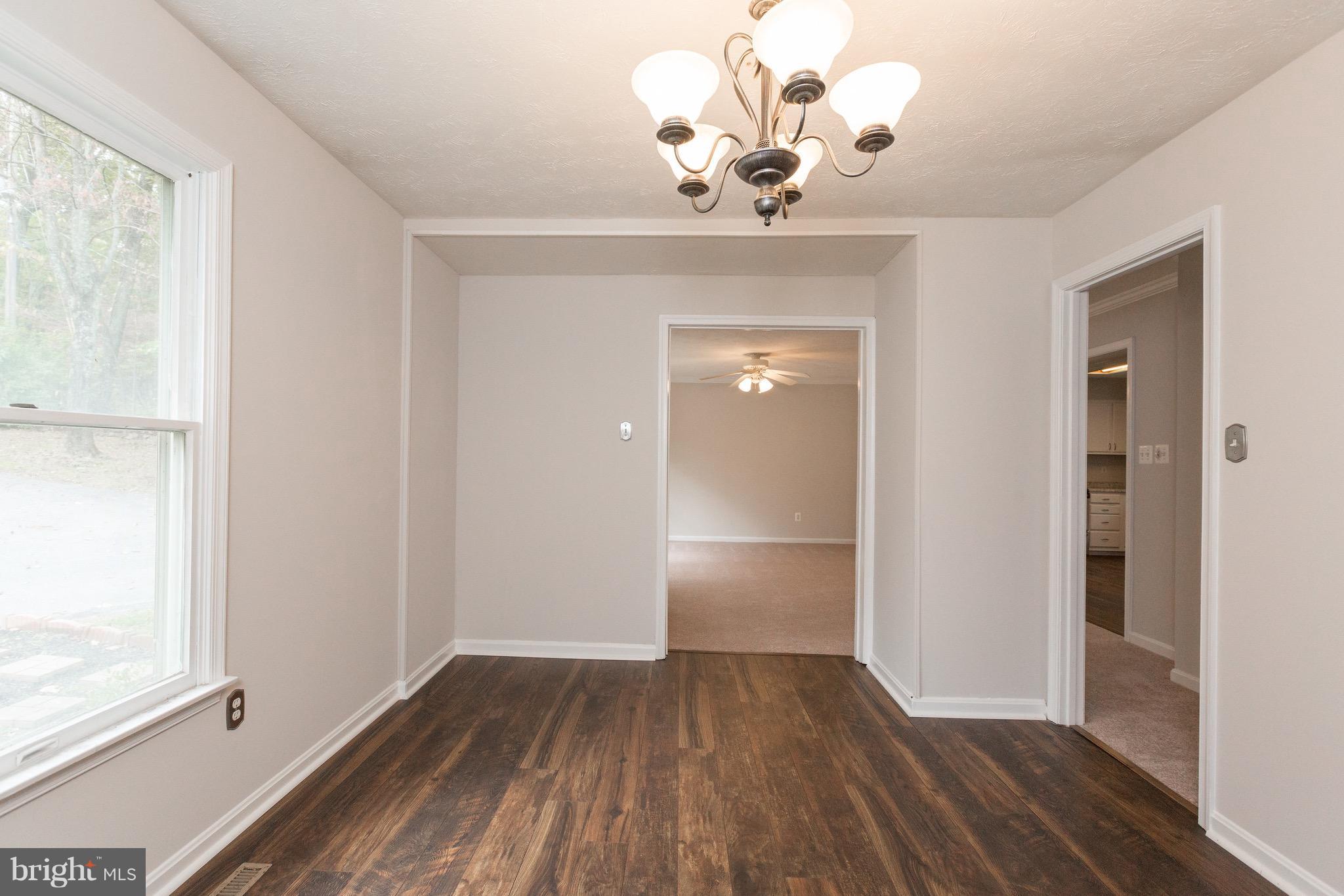 75 Locust Tree Lane Front Royal, VA 22630 - Photo 7 of 27 wooden floor in an empty room with a window
