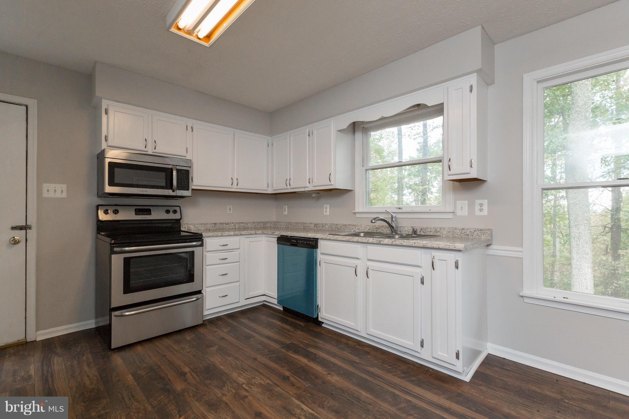 75 Locust Tree Lane Front Royal, VA 22630 - Photo 8 of 27 a kitchen with granite countertop wooden floors appliances and window