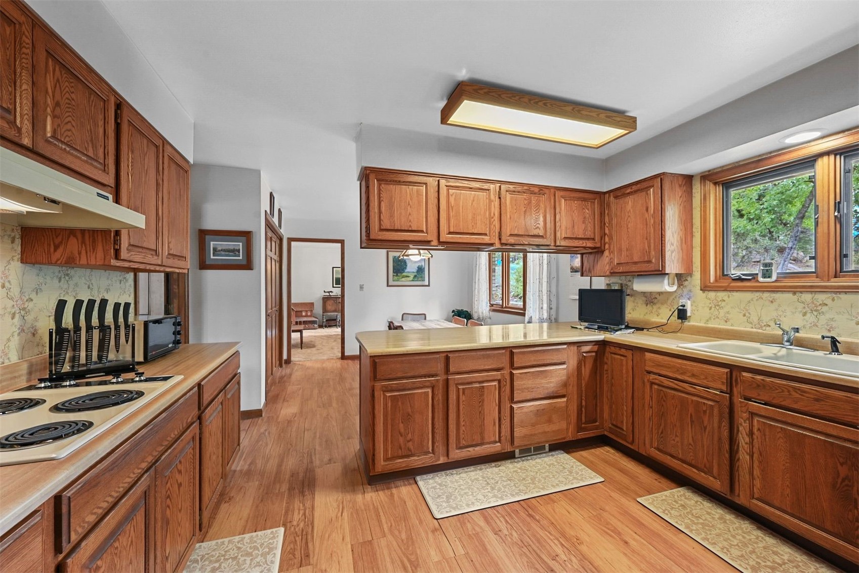 901 County Road 64 Bailey, CO 80421 - Photo 12 of 41 a kitchen with stainless steel appliances granite countertop wooden floor sink stove and wooden cabinets