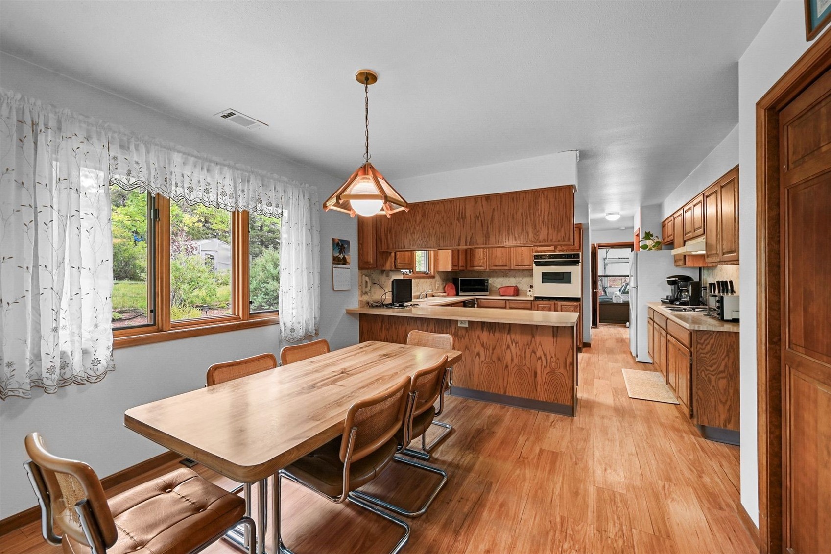 901 County Road 64 Bailey, CO 80421 - Photo 14 of 41 a kitchen with stainless steel appliances kitchen island granite countertop wooden floors refrigerator and dining table