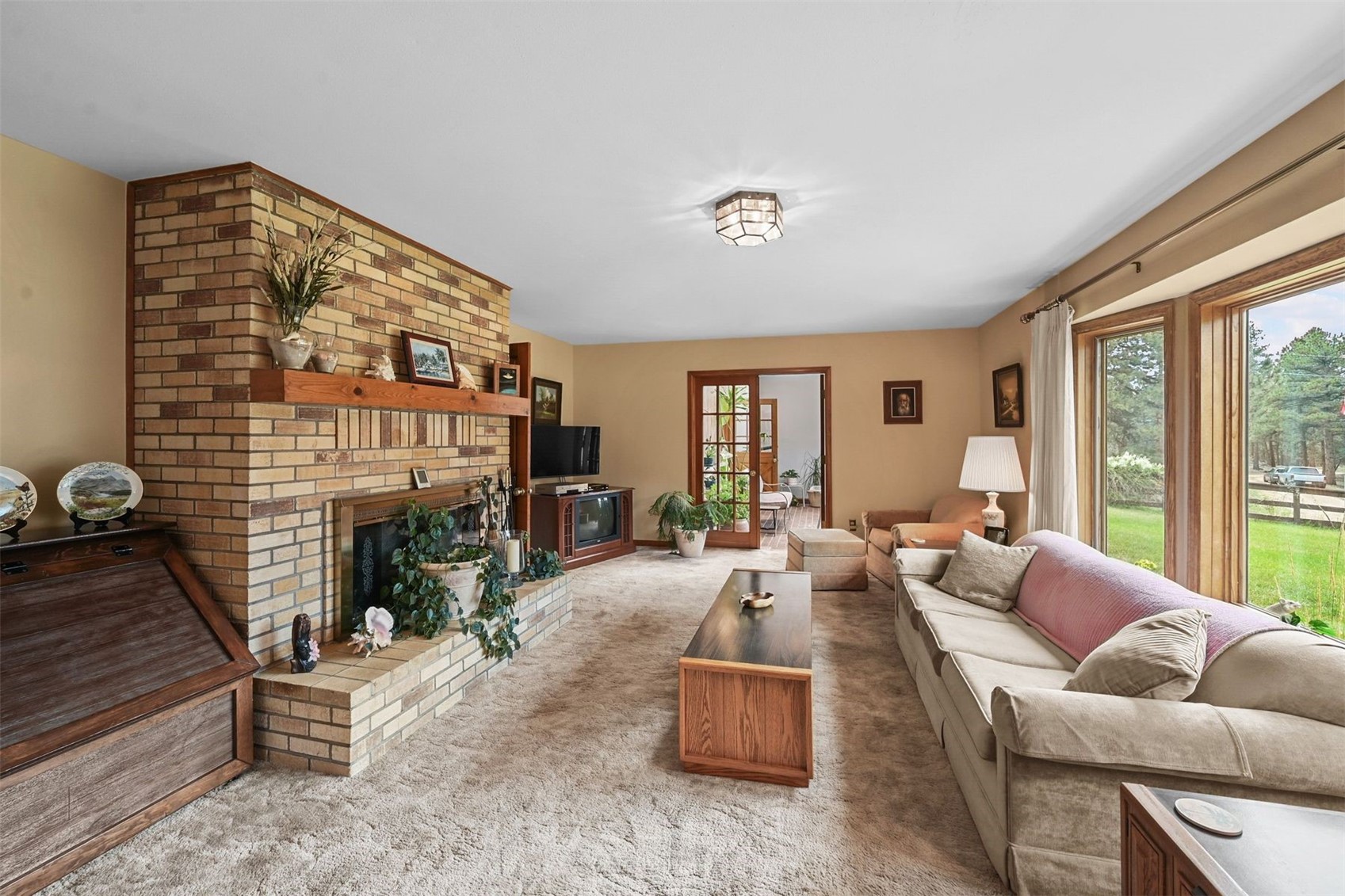 901 County Road 64 Bailey, CO 80421 - Photo 9 of 41 a living room with furniture large window and a fireplace