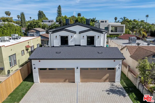 an aerial view of a house with a yard