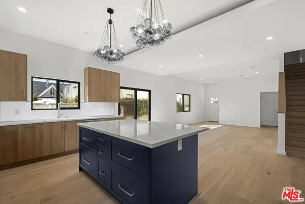 a bathroom with a granite countertop sink a large mirror and a shower