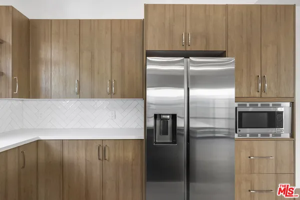 a kitchen with a refrigerator and microwave