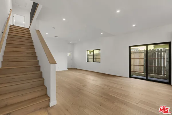 a view of an entryway with wooden floor