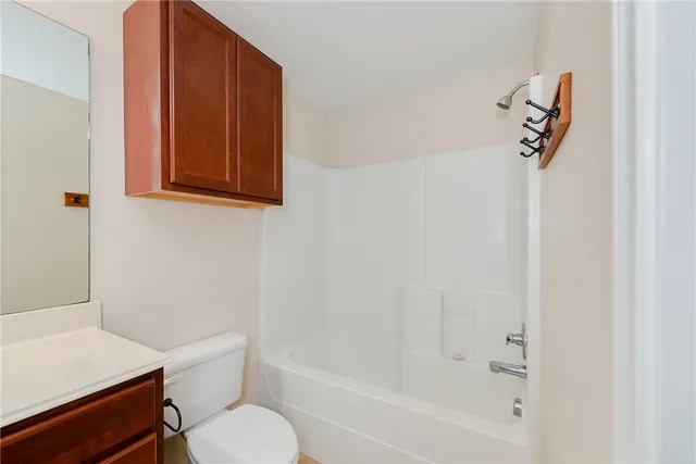 a bathroom with a toilet and a bathtub