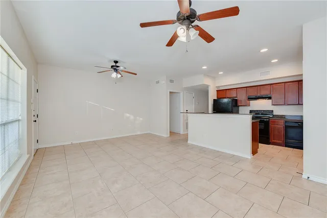 a view of a kitchen with a sink and a refrigerator