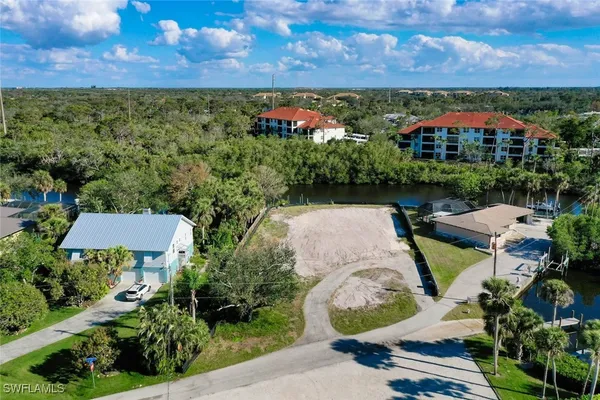 an aerial view of a house with a yard basket ball court and outdoor seating