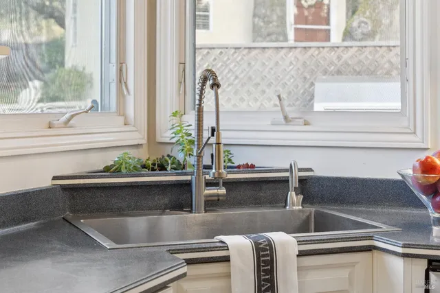 a kitchen with granite countertop a stove and a refrigerator