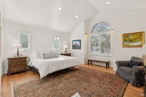 a spacious bedroom with a bed and a couch