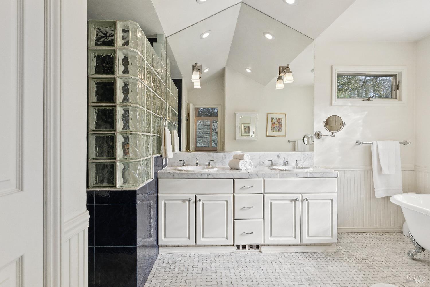 3556 Wood Valley Road Sonoma, CA 95476 - Photo 17 of 40 a spacious bathroom with a double vanity sink a toilet a mirror and shower