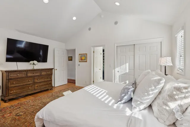a bedroom with bed and flat screen tv