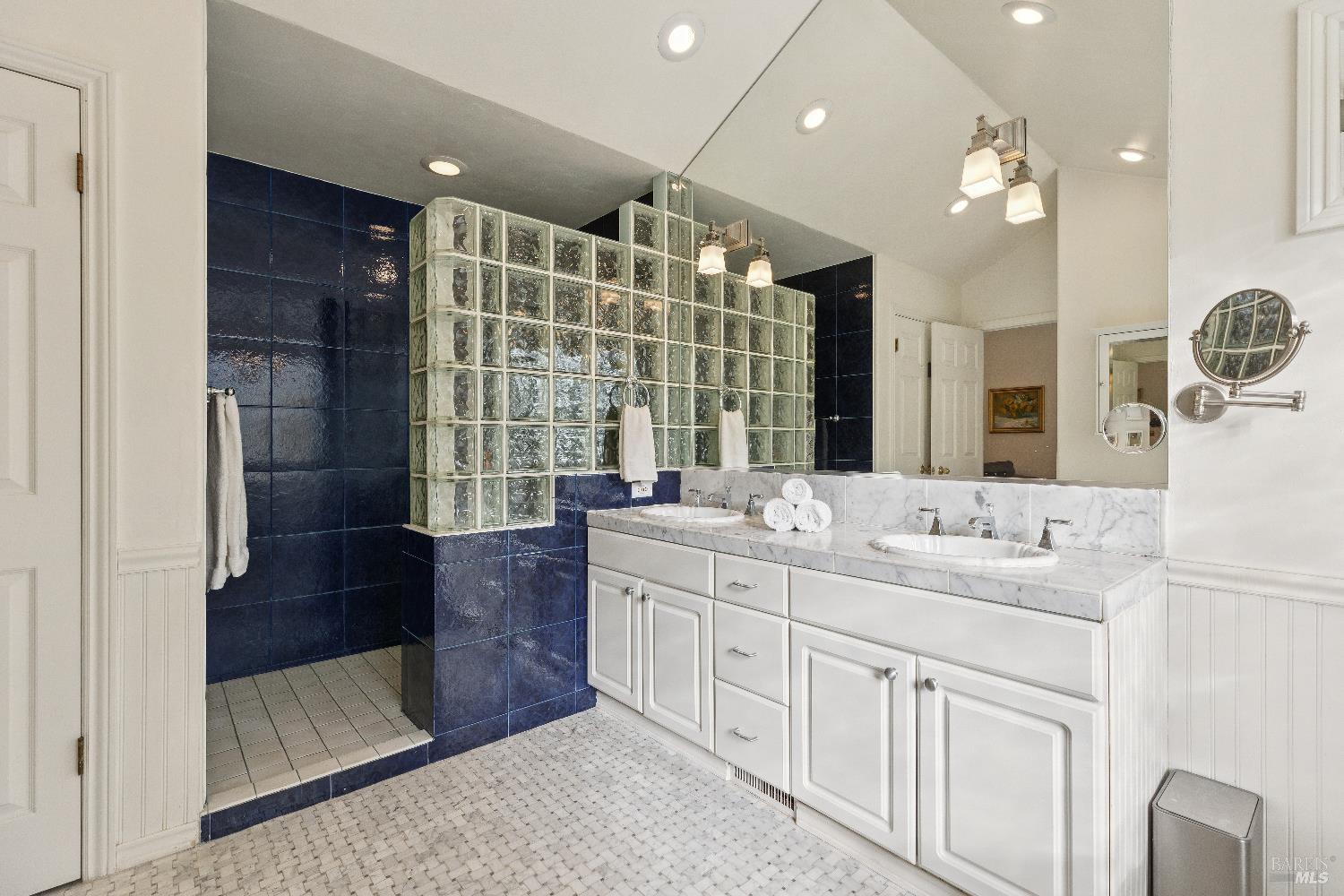 3556 Wood Valley Road Sonoma, CA 95476 - Photo 19 of 40 a bathroom with a double vanity sink a mirror and a shower