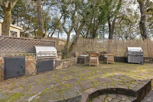 a view of a patio with table and chairs with wooden fence and floor