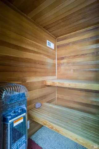 a view of a patio with table and chairs with wooden fence and floor