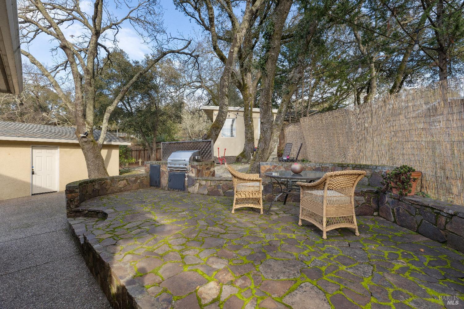 3556 Wood Valley Road Sonoma, CA 95476 - Photo 32 of 40 a view of a patio with table and chairs with wooden fence and floor