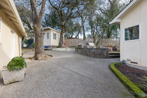a view of a patio with table and chairs with wooden fence and floor