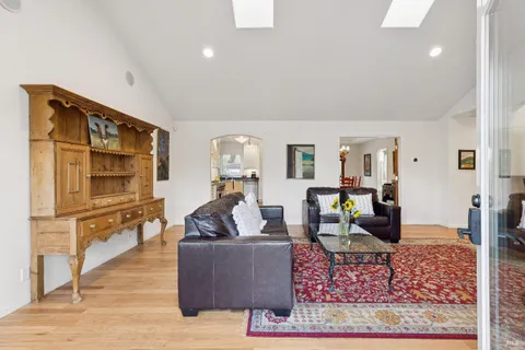 a living room with furniture wooden floor and a rug