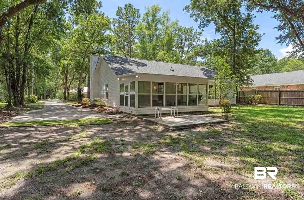 10251 Windmill Road Fairhope, AL 36532 - Photo 40 of 44 Rear view of property with a sunroom, a chimney, and a patio