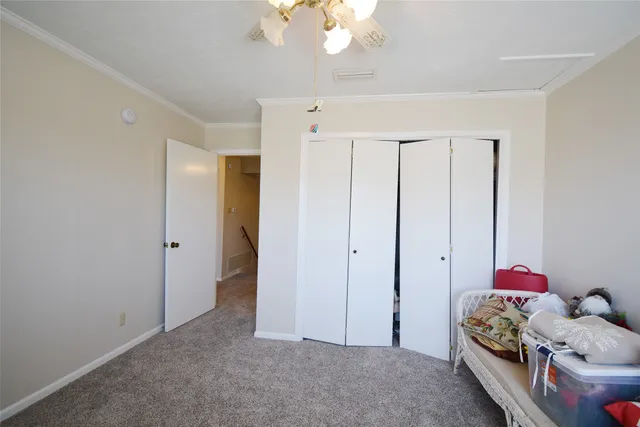 a bedroom with a bed and chandelier