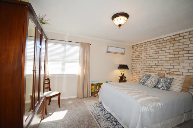 a bedroom with a bed and a lamp next to a window