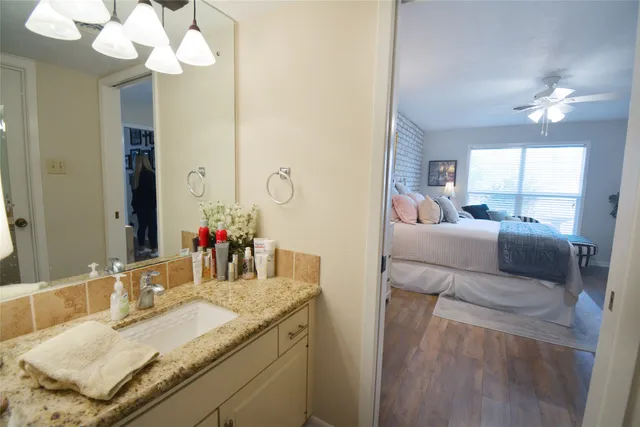 a bathroom with a sink mirror and vanity