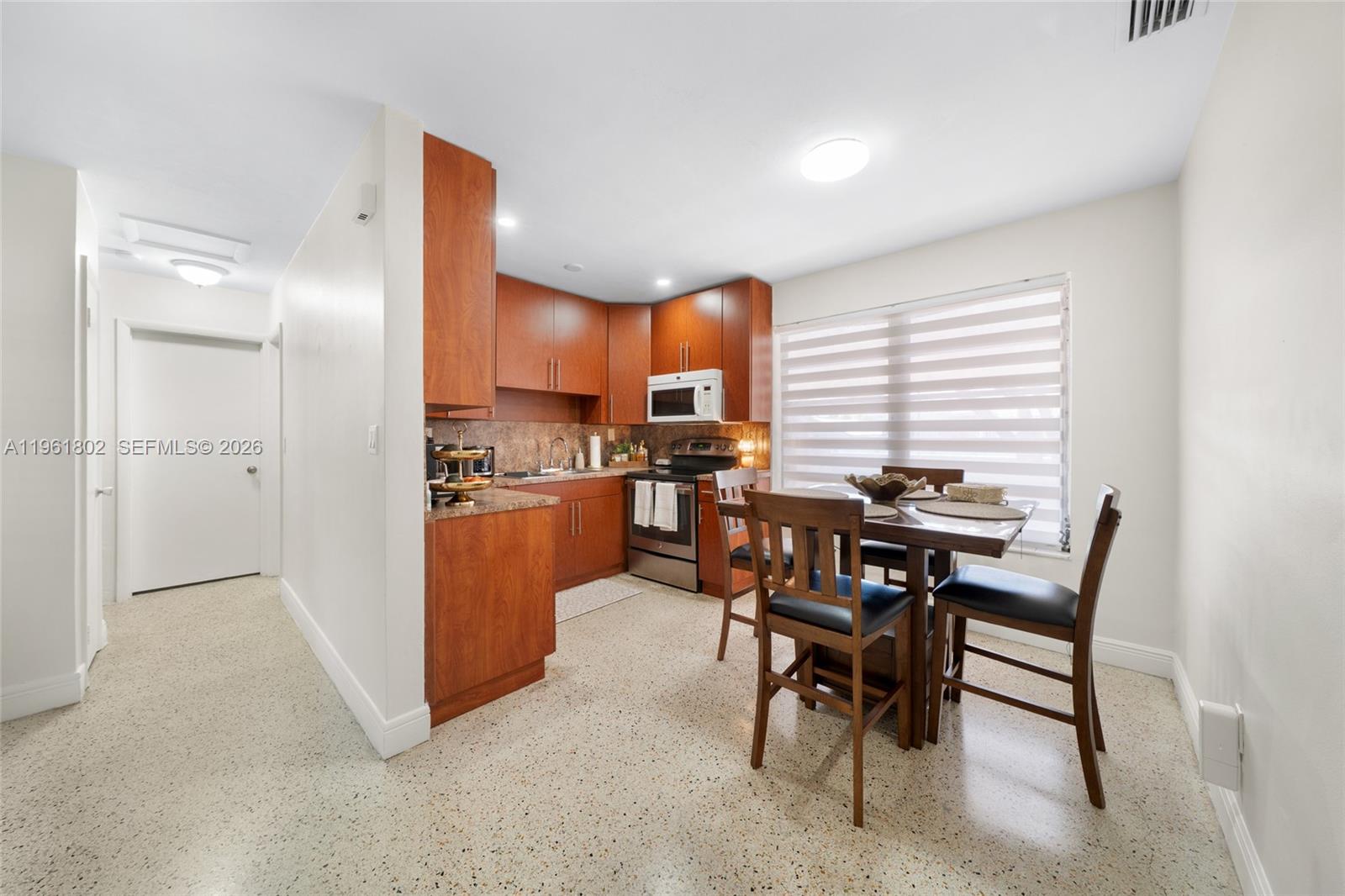 1166 West 24th Street Hialeah, FL 33010 - Photo 22 of 45 a view of a dining room with furniture and a window