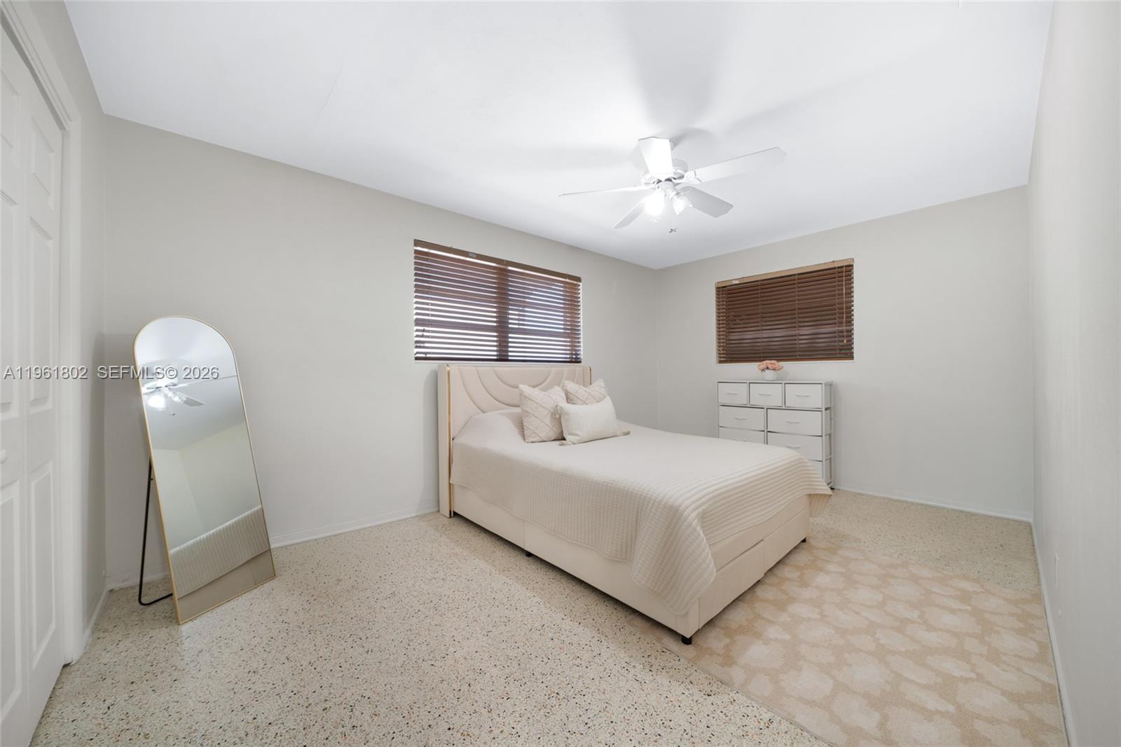 1166 West 24th Street Hialeah, FL 33010 - Photo 29 of 45 a room with a bed and a chandelier
