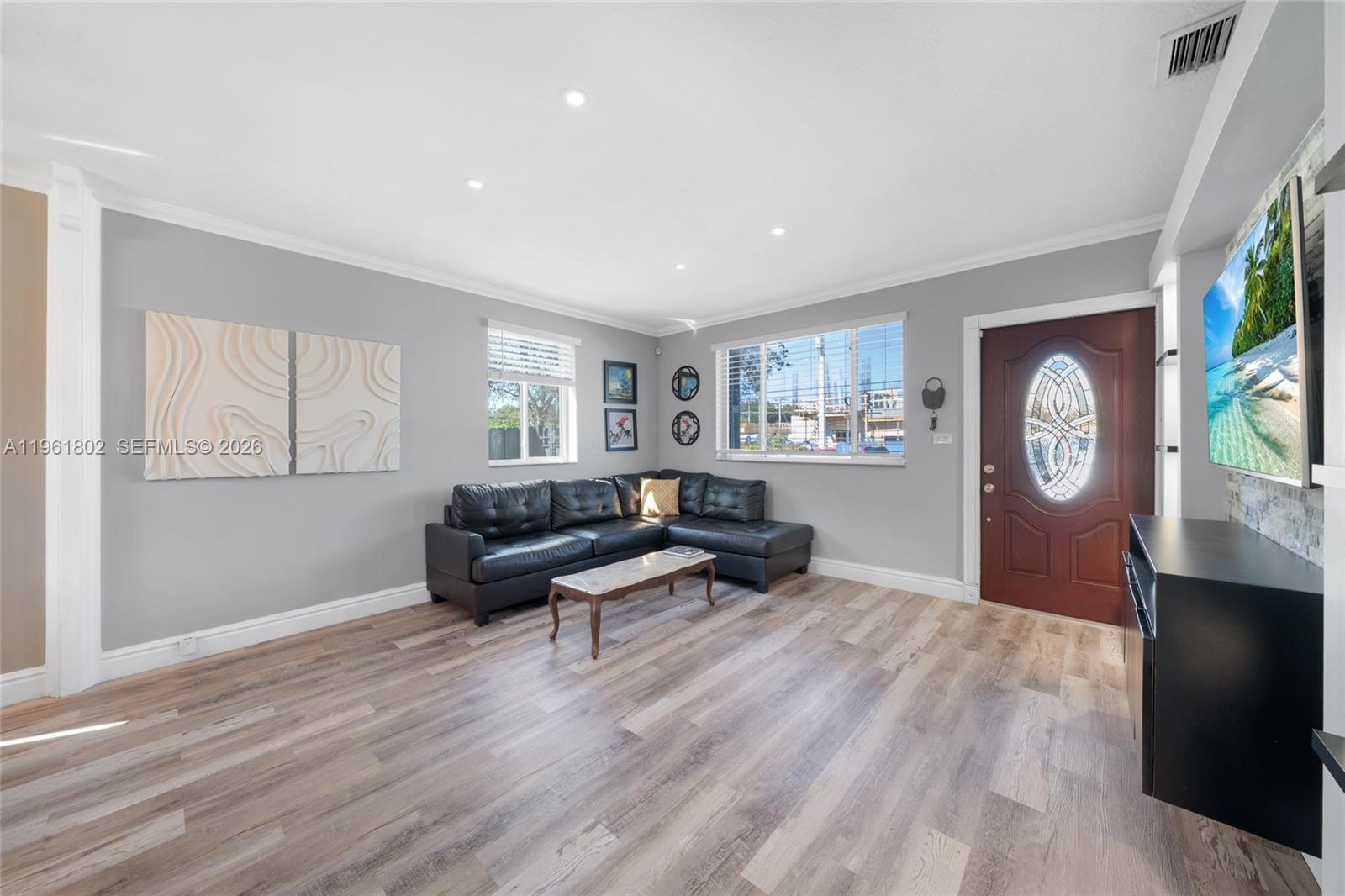 1166 West 24th Street Hialeah, FL 33010 - Photo 5 of 45 a living room with furniture and a wooden floor